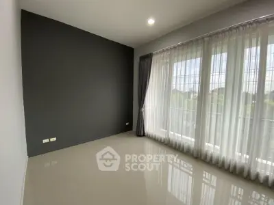 Spacious empty room with large windows and modern design, perfect for customization.