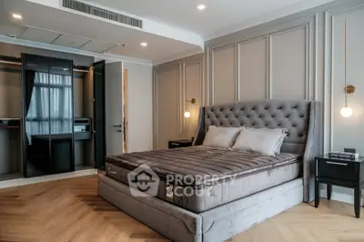 Luxurious bedroom with plush bed and walk-in closet, elegant lighting and modern design.