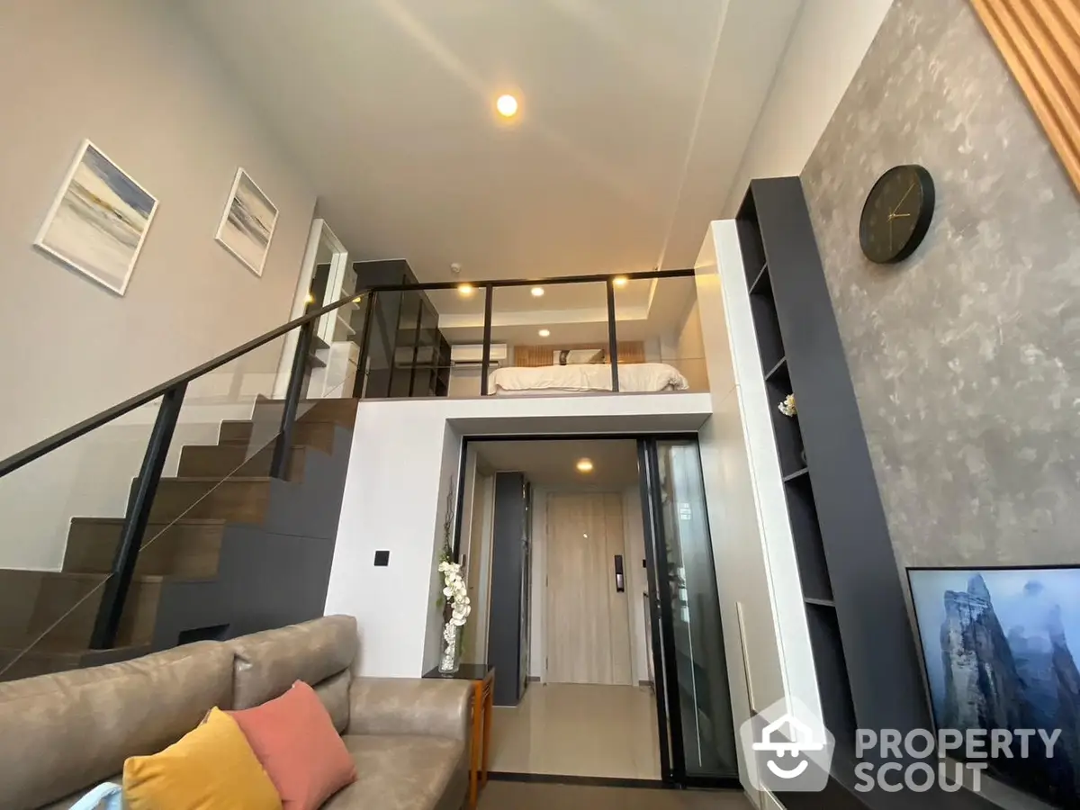 Chic duplex apartment with modern furnishings, elegant staircase leading to a cozy loft bedroom, and a sleek living area perfect for urban living.