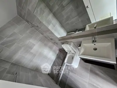 Modern bathroom with sleek tile design and contemporary fixtures.