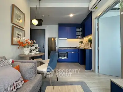 Modern open-layout kitchen and living room with blue cabinets and stylish decor