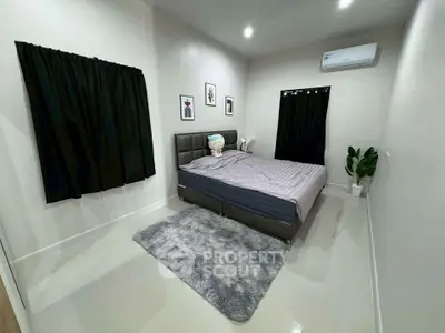 Modern bedroom with sleek design, featuring a cozy bed, stylish decor, and air conditioning for ultimate comfort.