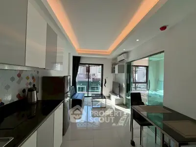 Modern open-plan living room with sleek kitchen and stylish lighting