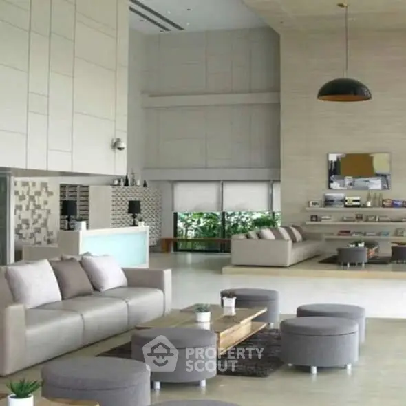 Luxurious modern living room with elegant decor and ample natural light.