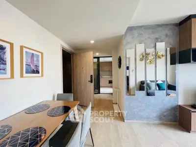 Modern open-plan living and dining area with stylish decor and natural light.