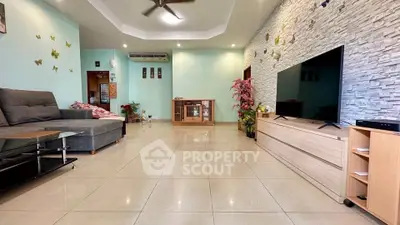 Spacious living room with modern decor and large TV, ideal for family gatherings.