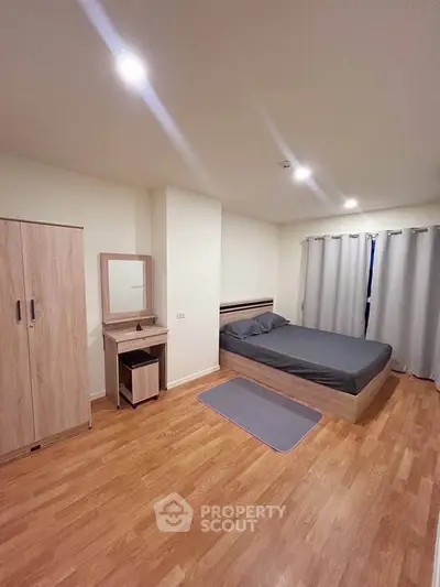 Modern bedroom with wooden flooring and minimalist furniture design
