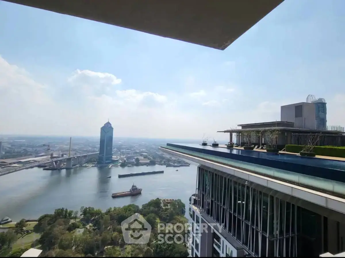 Stunning high-rise view overlooking a river and cityscape, featuring modern architecture and lush greenery.