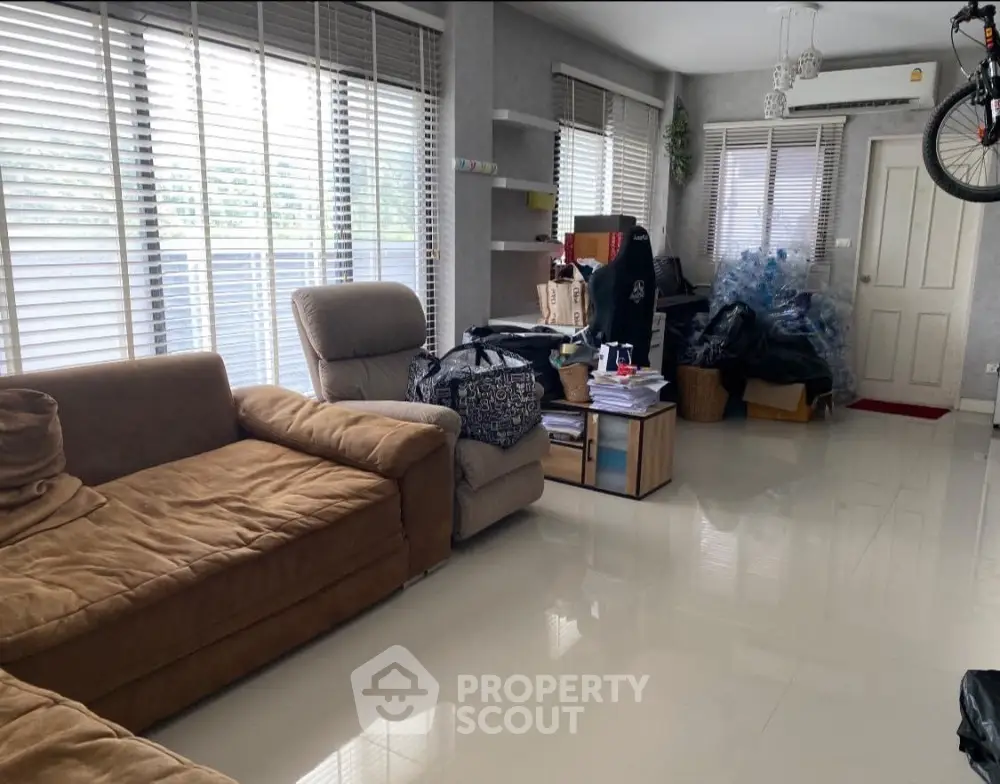 Spacious living room with modern furniture and large windows for natural light.