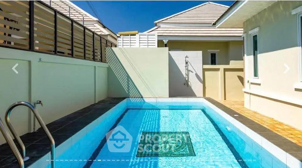 Luxurious private pool in modern residential backyard with elegant design and sunny ambiance.