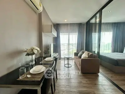 Modern studio apartment with open layout, featuring a cozy living area and dining space, perfect for urban living.