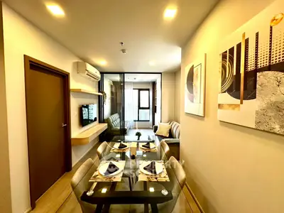 Modern living room with elegant dining area and stylish decor in a cozy apartment.