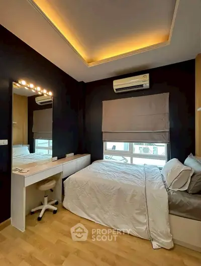 Modern bedroom with stylish lighting and cozy bedding in a contemporary apartment.