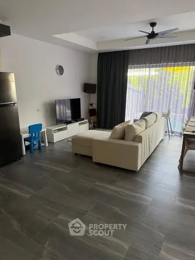 Spacious modern living room with large windows and stylish decor
