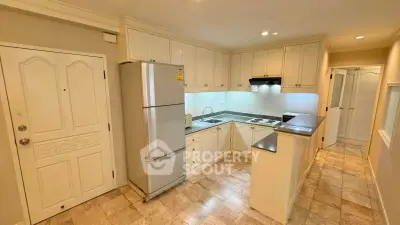 Charming kitchen with closed layout and modern appliances in cozy apartment