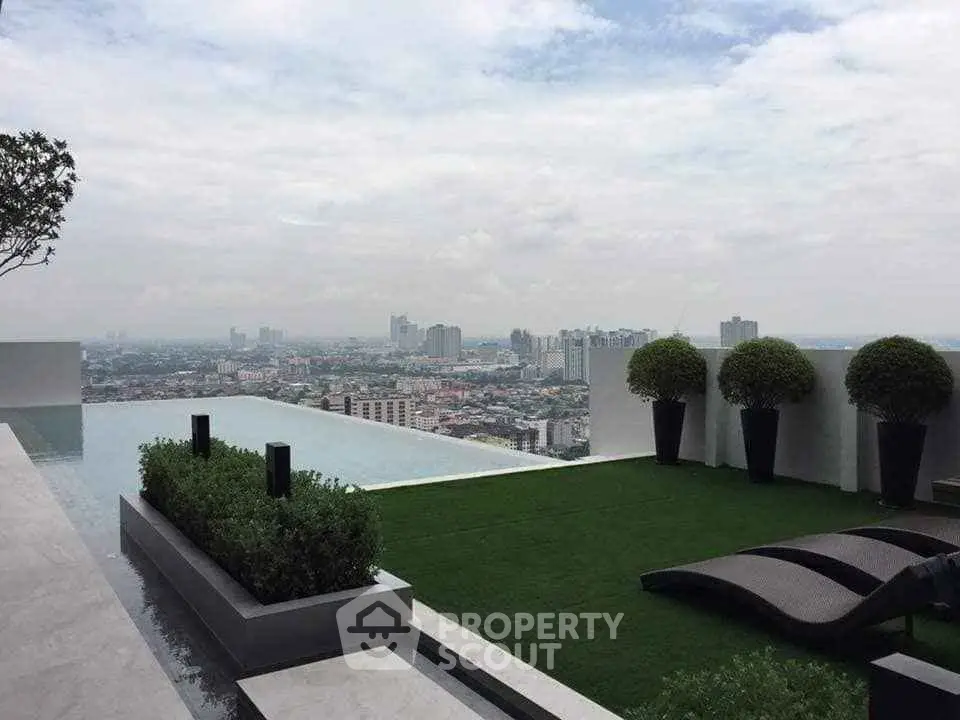 Luxurious rooftop pool with stunning city view and modern landscaping.