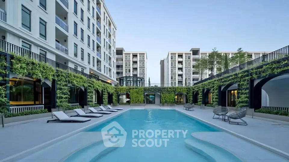 Luxurious apartment complex with stunning pool and modern architecture.