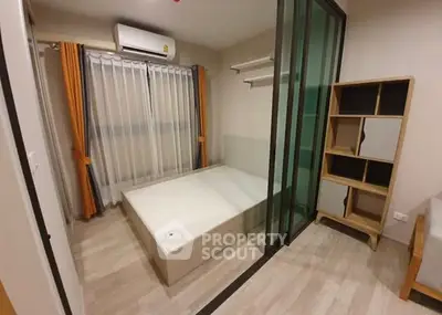 Modern bedroom with sliding glass doors and stylish shelving unit