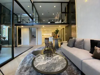 Luxurious modern living room with mezzanine, stylish decor, and open layout.