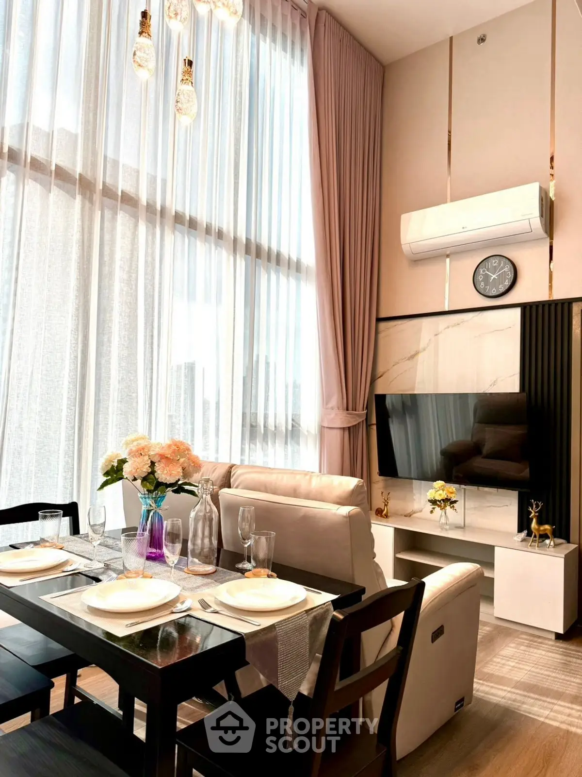 Luxurious high-ceiling living room with elegant dining area and modern decor