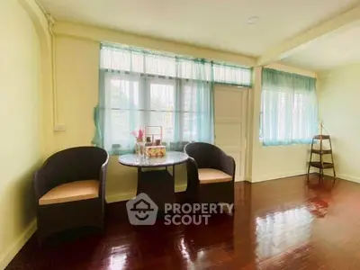 Charming living room with hardwood floors and cozy seating area, perfect for relaxation.