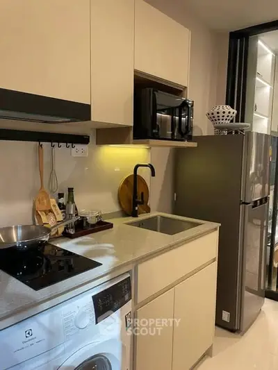 Modern kitchen with sleek appliances and compact design