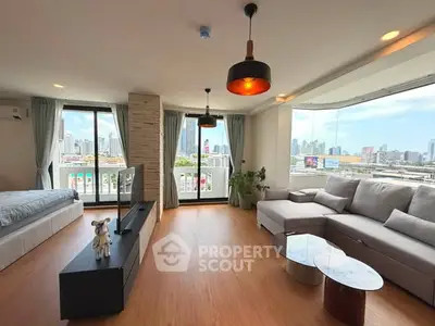 Spacious modern living room with panoramic city views and stylish decor