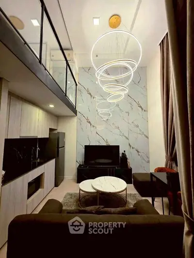 Luxurious modern living room with high ceilings, elegant lighting, and stylish decor in a contemporary apartment.