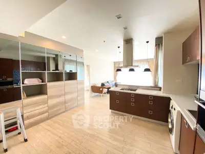 Spacious modern living area with open kitchen and stylish wooden flooring