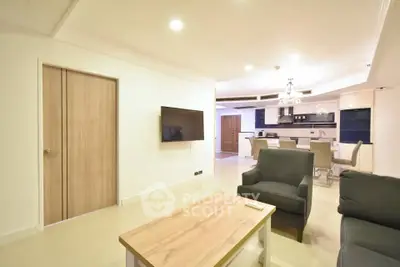 Spacious modern living room with open kitchen layout and stylish furniture