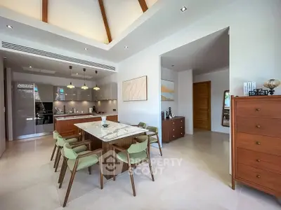 Modern dining area with elegant wooden furniture and open kitchen layout