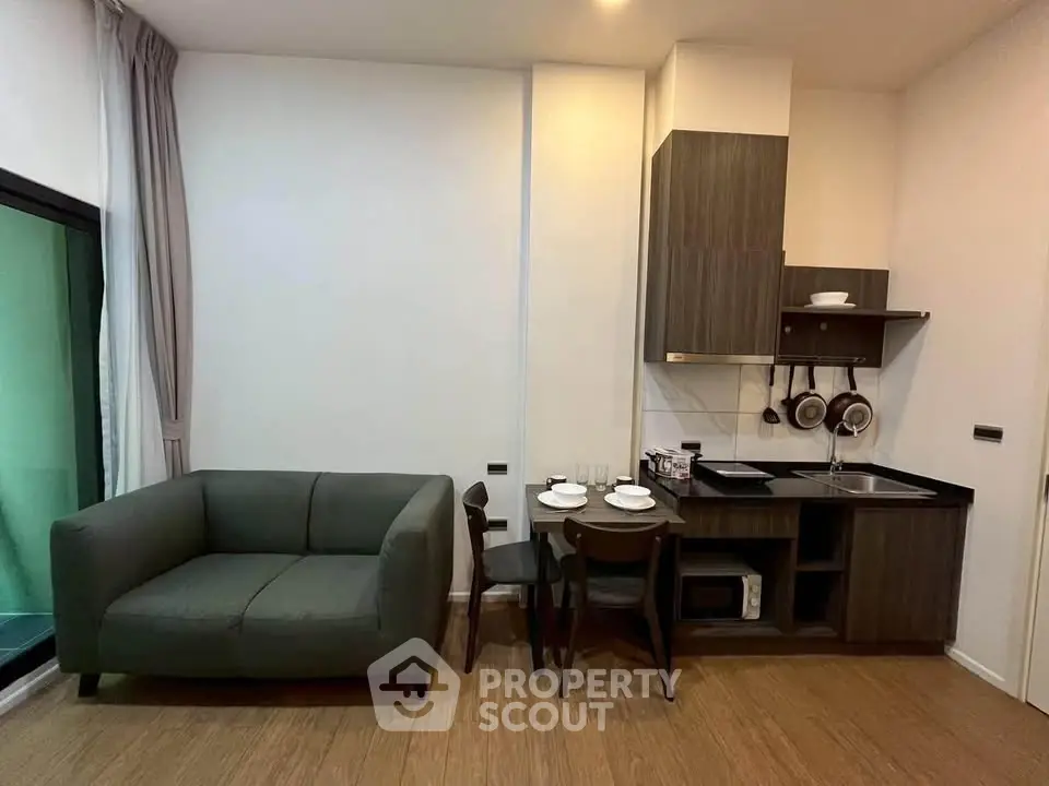 Modern studio apartment with cozy living area and compact kitchen