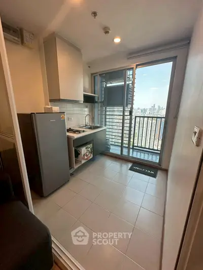 Modern kitchen with city view from balcony in high-rise apartment