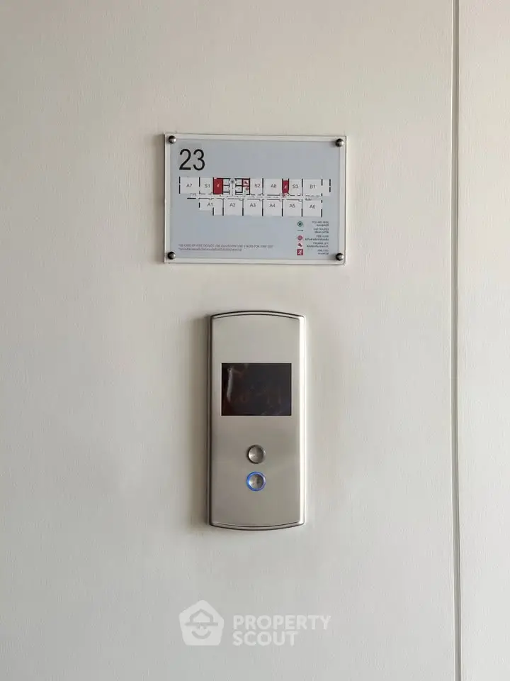 Modern elevator panel on 23rd floor with floor plan display, sleek design for contemporary buildings.
