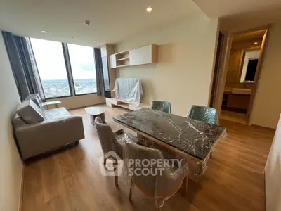 Modern living room with panoramic city view and stylish furniture.