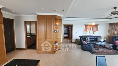 Spacious living room with elegant wooden cabinetry and modern decor in a luxury apartment.