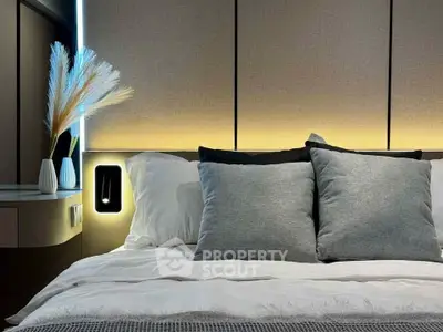 Luxurious modern bedroom with elegant lighting and plush pillows, perfect for relaxation and comfort.