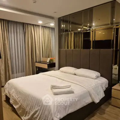 Luxurious bedroom with elegant decor and large windows for natural light.