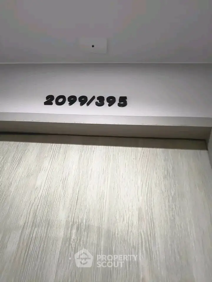 Modern apartment door with unit number 2099/395, showcasing sleek design and contemporary style.
