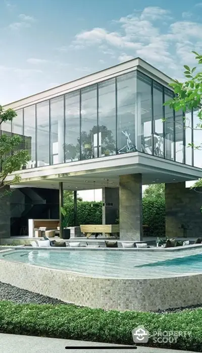 Luxurious modern home with glass facade and stunning pool area