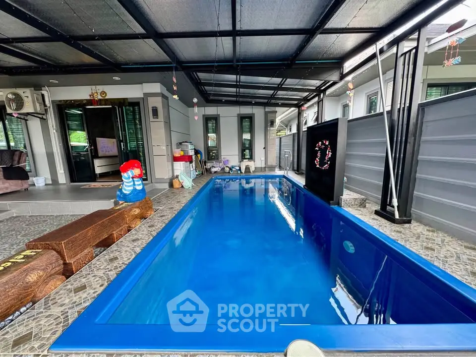 Luxurious private indoor pool with modern design and seating area, perfect for relaxation.