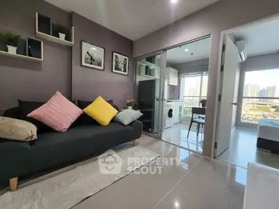 Modern living room with stylish decor and city view, featuring a cozy sofa and vibrant cushions.