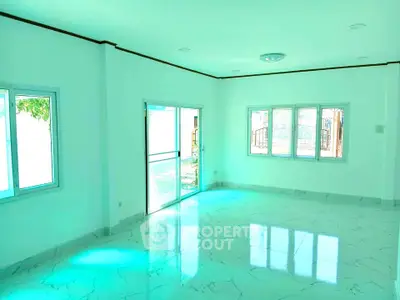 Spacious and bright living room with large windows and marble flooring