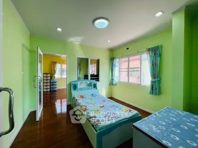 Bright and cheerful bedroom with colorful decor and ample natural light