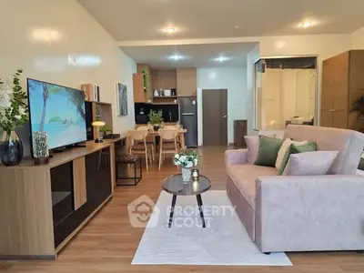 Modern open-plan living room with stylish decor and cozy seating area.
