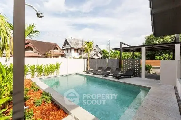 Luxurious private pool area with modern design and lush landscaping in a serene residential setting.