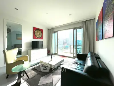 Modern living room with city view, stylish furniture, and large windows in a high-rise apartment.