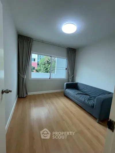 Cozy minimalist living room with natural light and modern sofa