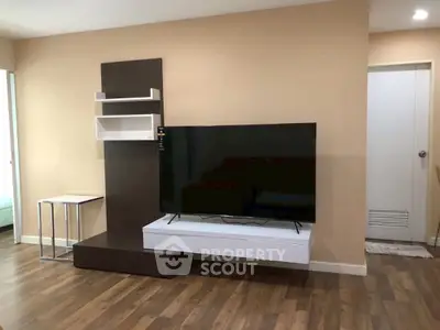 Modern living room with sleek TV stand and wooden flooring, perfect for cozy entertainment.