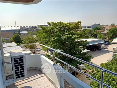 Spacious balcony with scenic view of lush greenery and urban landscape, perfect for relaxation and outdoor enjoyment.